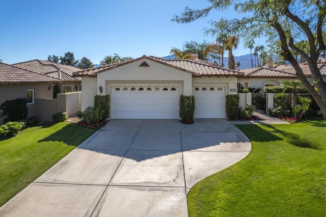 mediterranean / spanish home with a front lawn and a garage