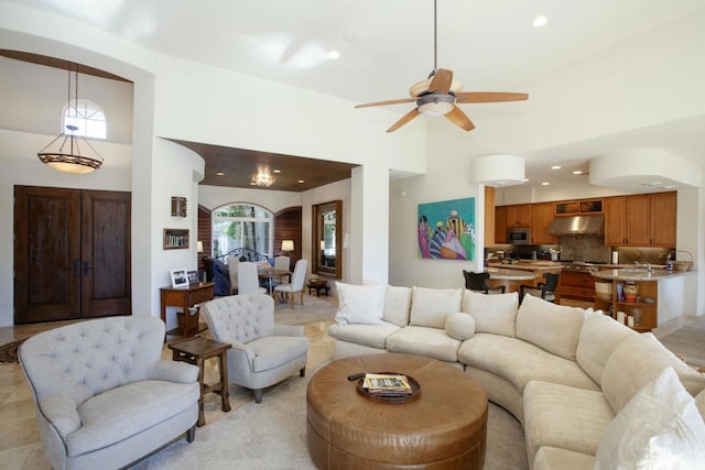 living room featuring a towering ceiling and ceiling fan