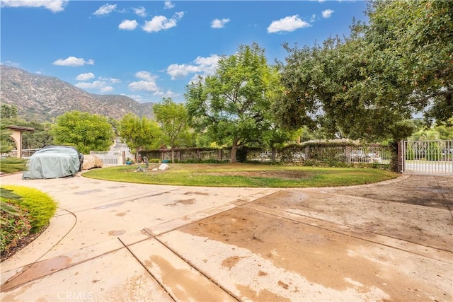 exterior space with a mountain view, a yard, and a patio area