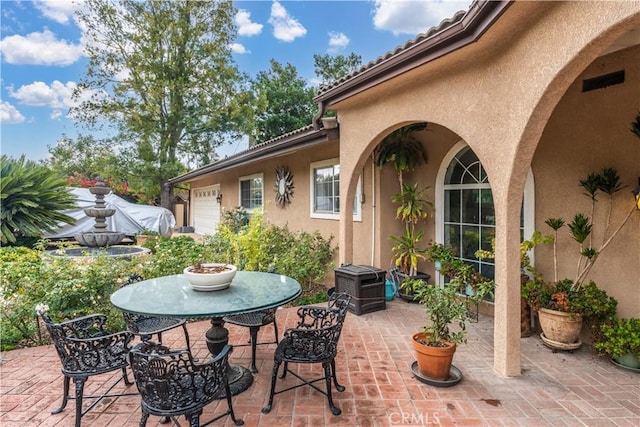 view of patio featuring a garage