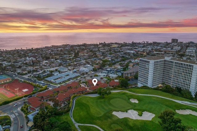 aerial view at dusk featuring a water view