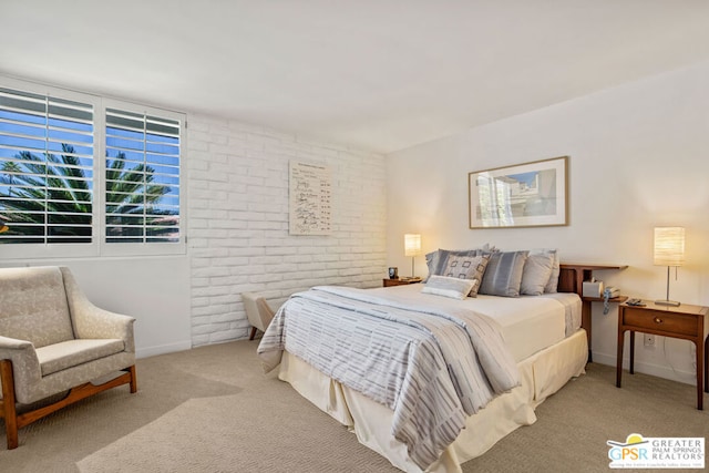 carpeted bedroom featuring brick wall