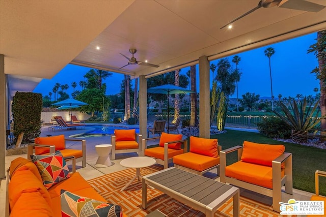 patio terrace at dusk featuring outdoor lounge area, a yard, a fenced in pool, and ceiling fan