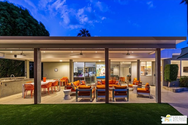 view of patio / terrace featuring outdoor lounge area, ceiling fan, area for grilling, and an outdoor wet bar