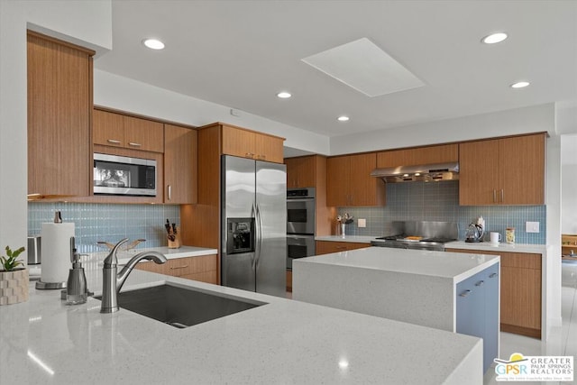 kitchen with backsplash, ventilation hood, sink, a kitchen island, and stainless steel appliances