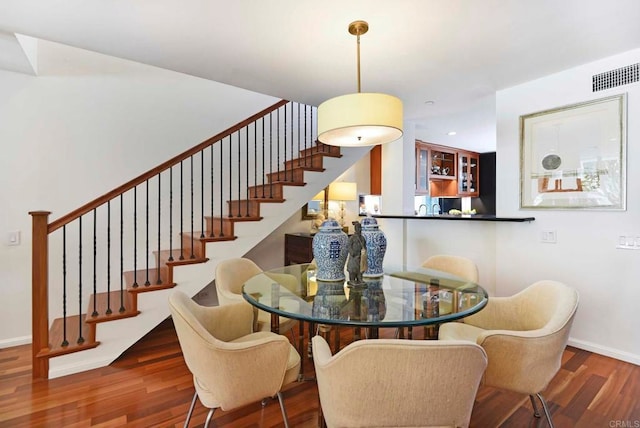 dining space with dark hardwood / wood-style flooring