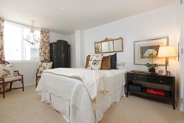 carpeted bedroom featuring a chandelier