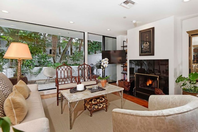 101 Coast Blvd Unit 1C, La Jolla, CA 92037 - living room featuring wood finished floors, recessed lighting, a warm lit fireplace, and floor to ceiling windows