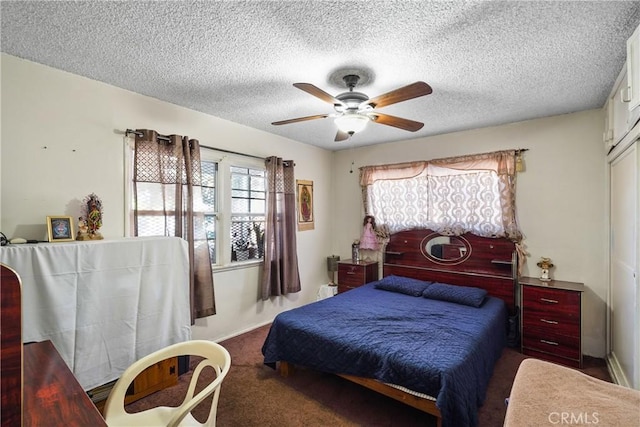 bedroom featuring carpet, ceiling fan, and a textured ceiling