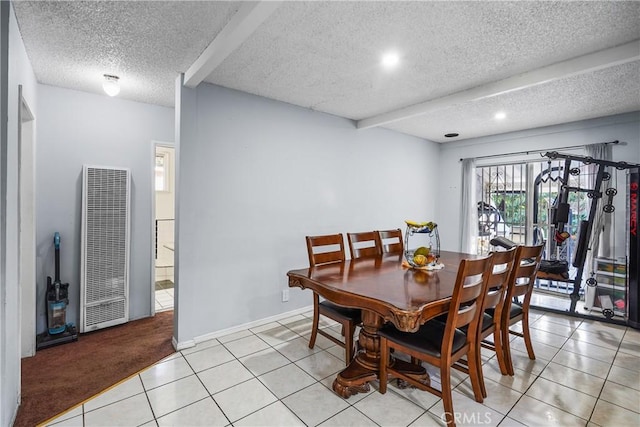 dining room with beamed ceiling, light colored carpet, and a textured ceiling