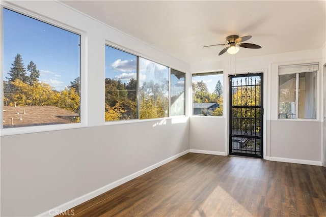 unfurnished sunroom with ceiling fan