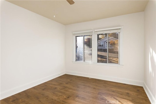 unfurnished room featuring ceiling fan and dark hardwood / wood-style flooring