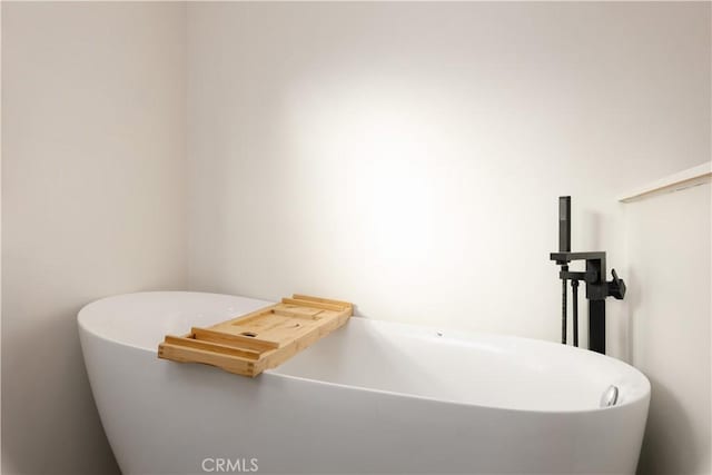 bathroom with a tub to relax in