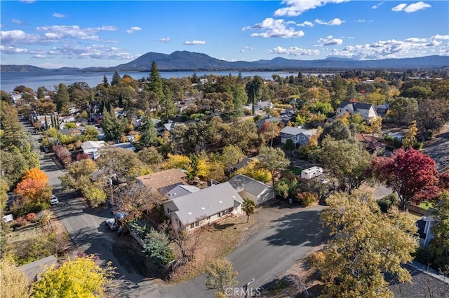 drone / aerial view featuring a water and mountain view