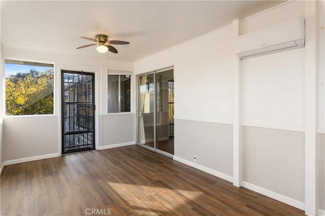 unfurnished room featuring dark hardwood / wood-style floors, ceiling fan, and an AC wall unit