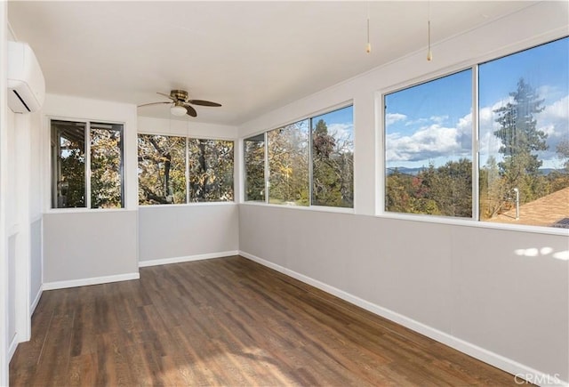 unfurnished sunroom with a wall mounted air conditioner and ceiling fan