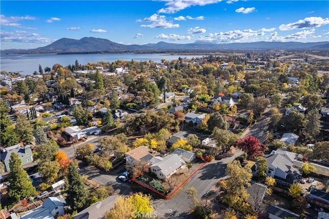 aerial view featuring a water and mountain view