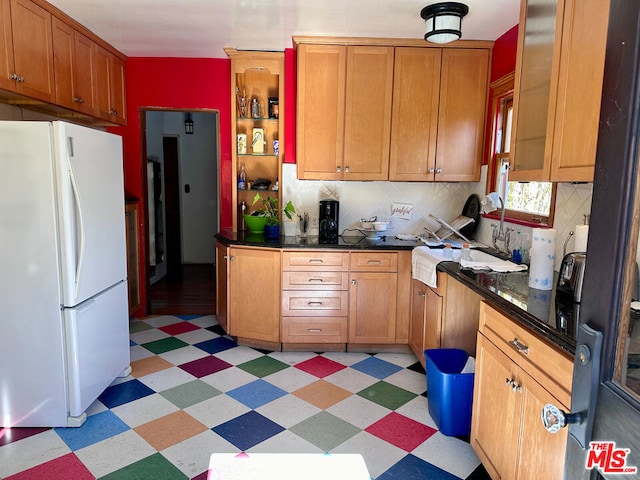 kitchen with decorative backsplash and white refrigerator