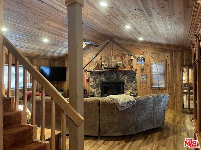 living room with wooden walls, hardwood / wood-style floors, wood ceiling, and lofted ceiling