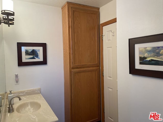 bathroom featuring vanity and a textured ceiling