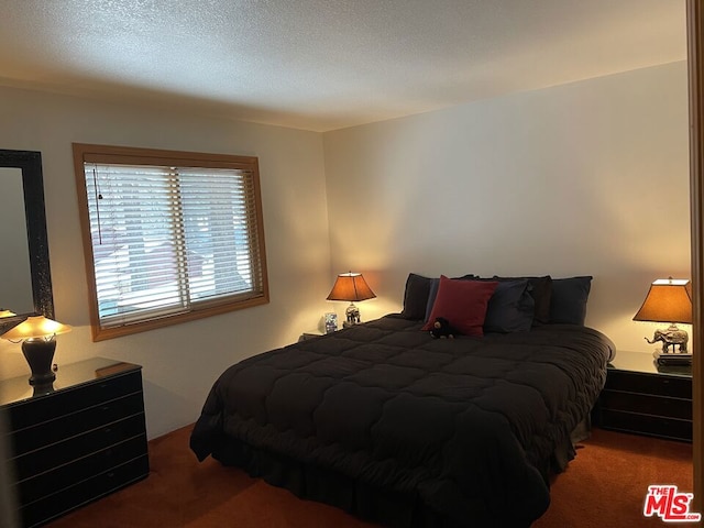 bedroom with carpet and a textured ceiling