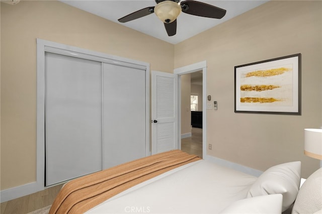 bedroom featuring wood-type flooring, a closet, and ceiling fan