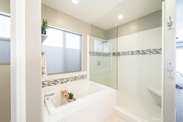 bathroom featuring tile patterned floors and independent shower and bath