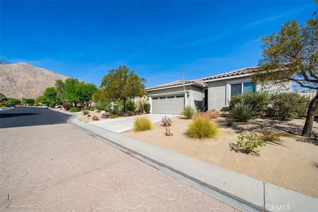 view of front of house featuring a mountain view and a garage