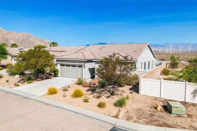 view of front of property featuring a mountain view and a garage