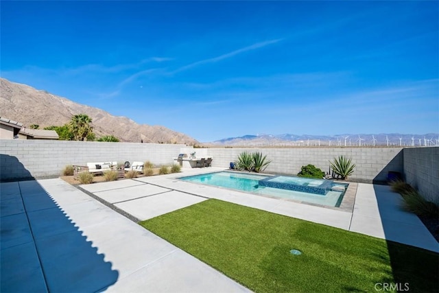 view of pool featuring a patio area and a mountain view