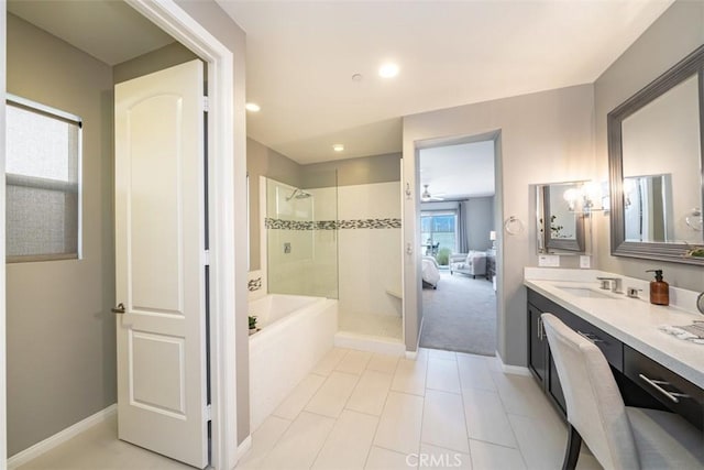 bathroom featuring tile patterned flooring, vanity, shower with separate bathtub, and a wealth of natural light