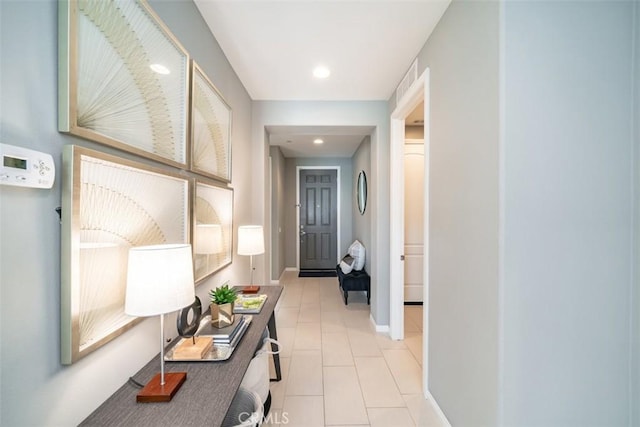 hall with light tile patterned floors