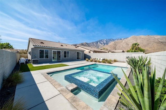 view of pool featuring an in ground hot tub, a mountain view, a patio, and central air condition unit