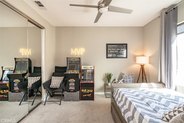 carpeted bedroom featuring a closet and ceiling fan