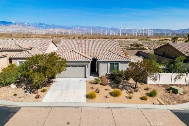 view of front of property with a mountain view and a garage