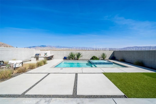 view of swimming pool with a patio area and a mountain view