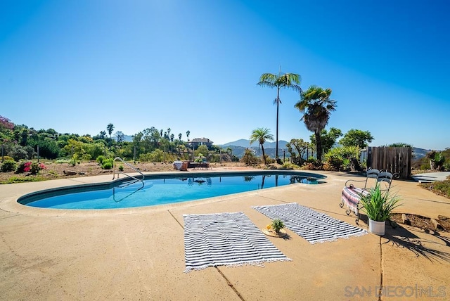 view of pool featuring a patio and a mountain view