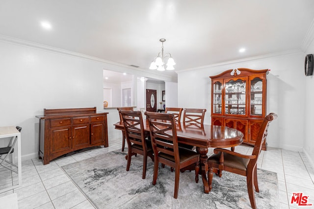 tiled dining room featuring crown molding and a chandelier