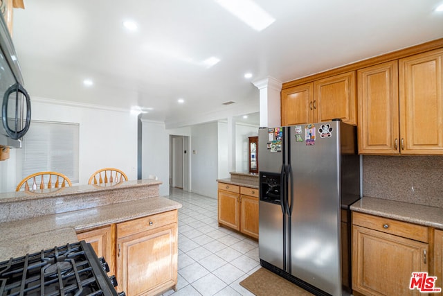 kitchen with decorative backsplash, stainless steel fridge, light stone counters, ornamental molding, and light tile patterned floors