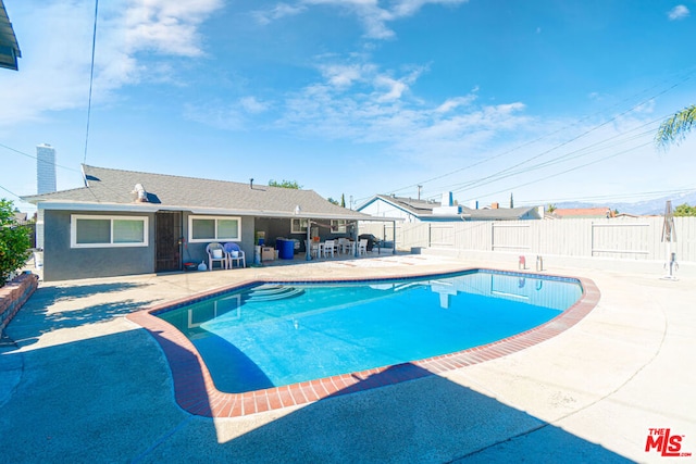 view of swimming pool with a patio