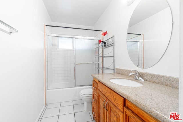 full bathroom featuring tile patterned flooring, vanity, enclosed tub / shower combo, and toilet