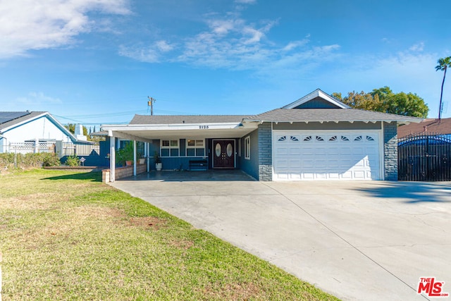 ranch-style home featuring a carport, a front yard, and a garage