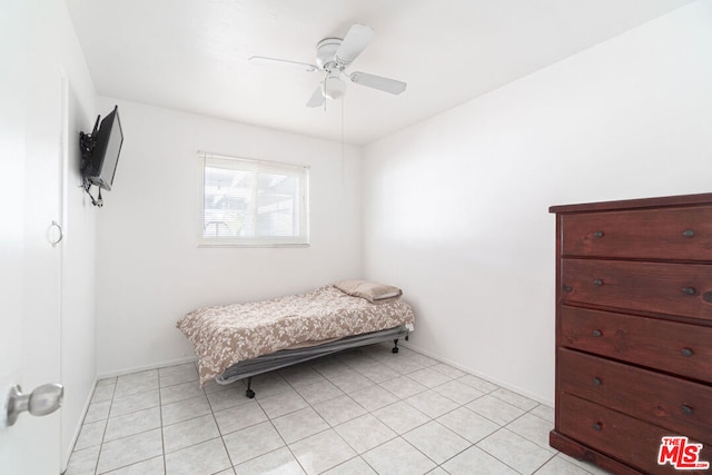 tiled bedroom featuring ceiling fan