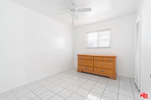 tiled bedroom with a closet and ceiling fan