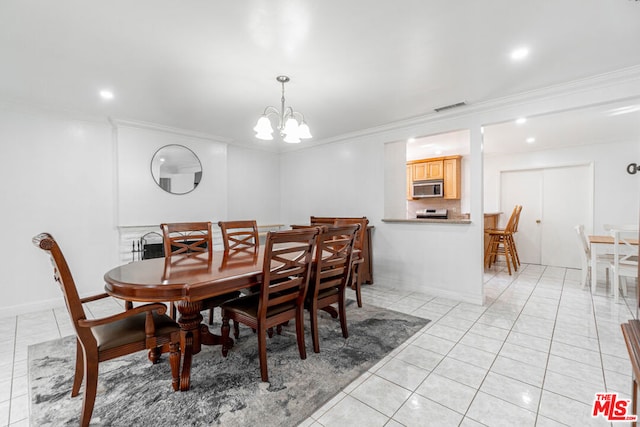 dining area featuring light tile patterned flooring, crown molding, and an inviting chandelier