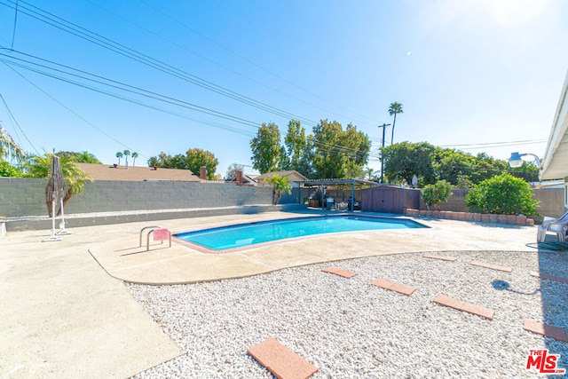 view of swimming pool featuring a patio area