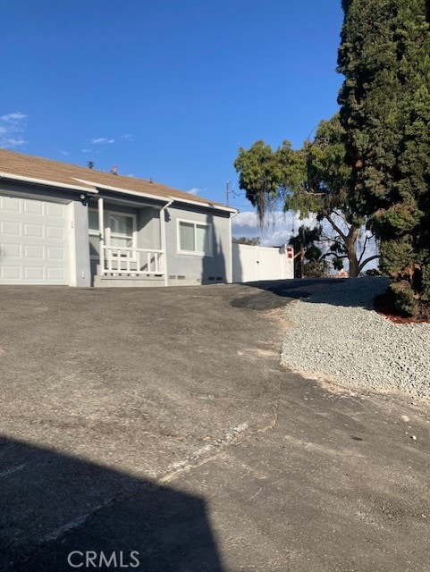 view of front of property with a porch and a garage