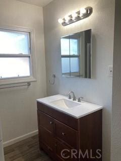 bathroom with plenty of natural light, wood-type flooring, and vanity