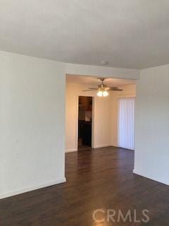 empty room featuring ceiling fan and dark hardwood / wood-style floors