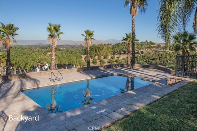 view of pool with a mountain view and a patio area